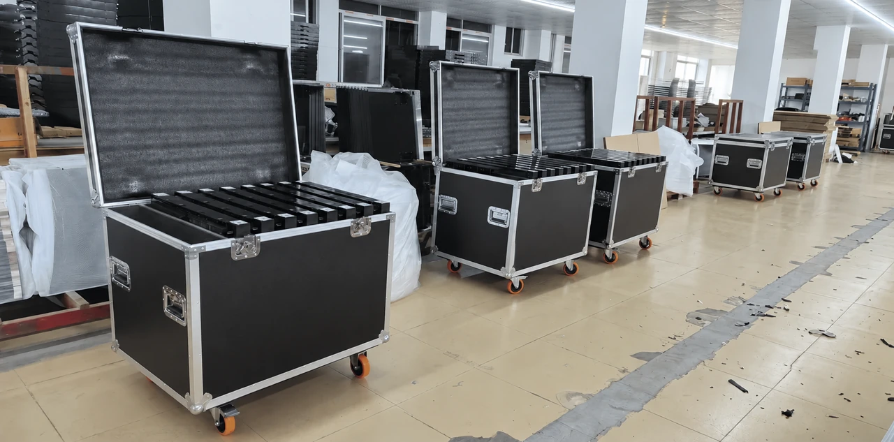 Unbranded flight cases holding dance floor panels in the factory packing area